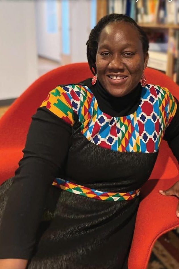 Sefakor seated on a red chair